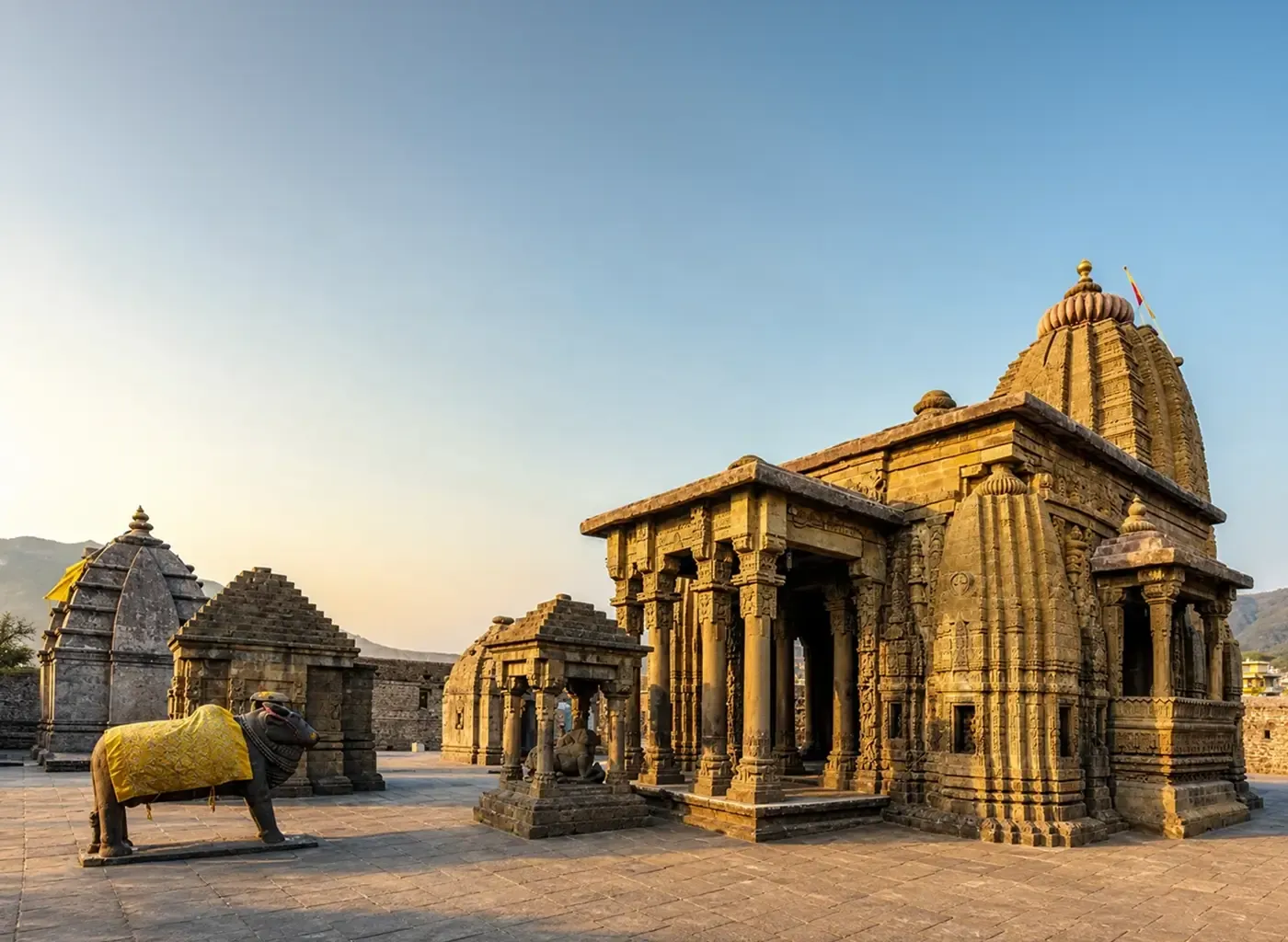 The stone shikhara of the Baijnath Shiva temple against the hills