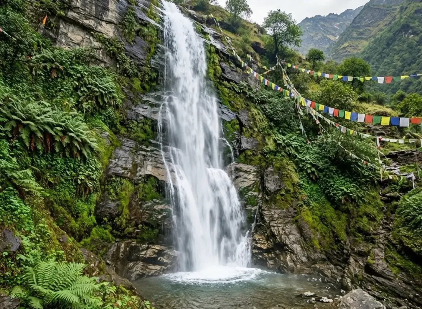 Bhagsu waterfall cascading over mossy rock