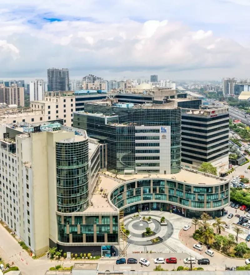 Welldone Techpark — curved glass office campus on Sohna Road